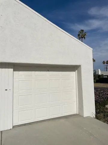 a view of a patio with a table chairs and a fire pit