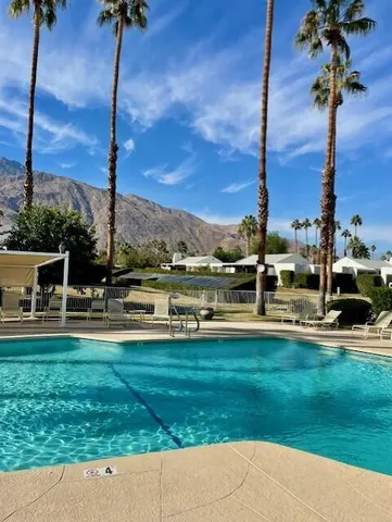 a view of a swimming pool with a yard and lake view