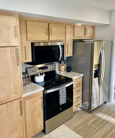 a kitchen with stainless steel appliances a refrigerator stove and microwave