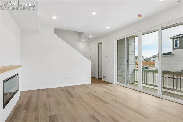 a view of an empty room and wooden floor