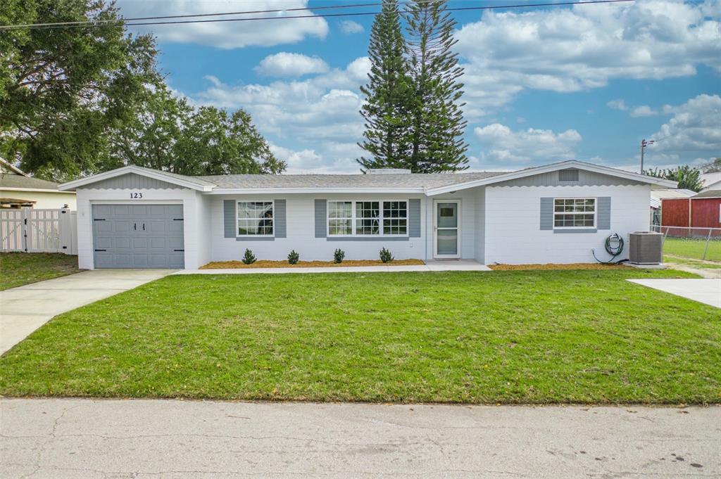 123 Lakeview Drive St. Cloud, FL 34769 - Photo 1 of 1 a front view of house with yard and green space