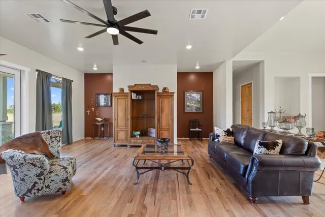 a living room with furniture and wooden floor