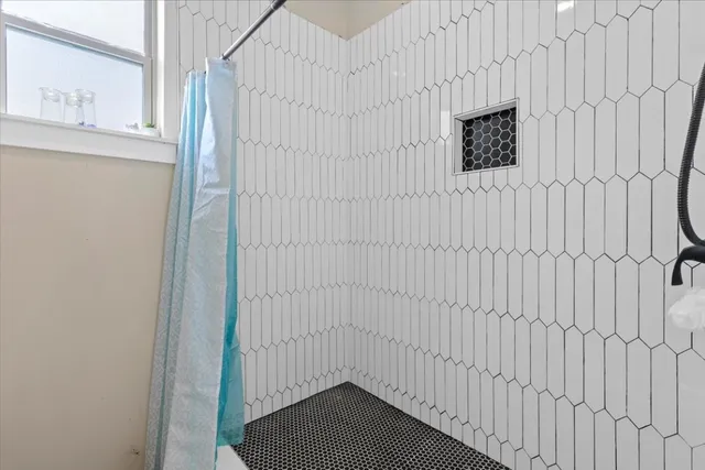 a front view of a house with a garden and lake view