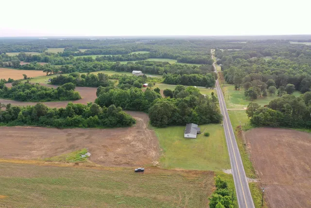 an aerial view of a house with a yard