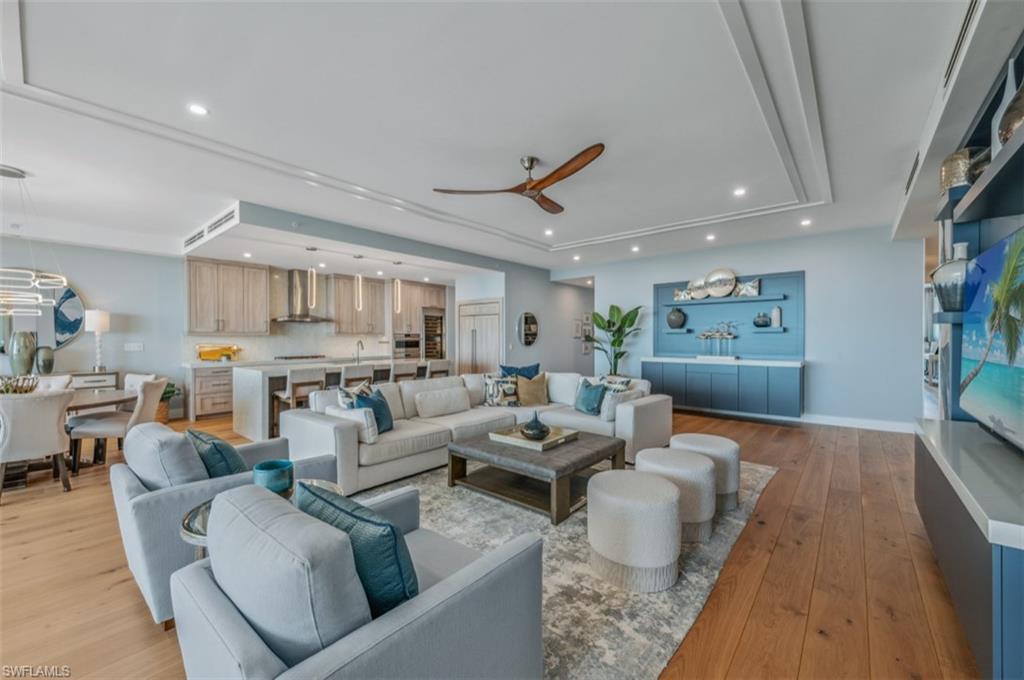 13925 Old Coast Road, Unit PH02 Naples, FL 34110 - Photo 12 of 33 a living room with furniture and a wooden floor
