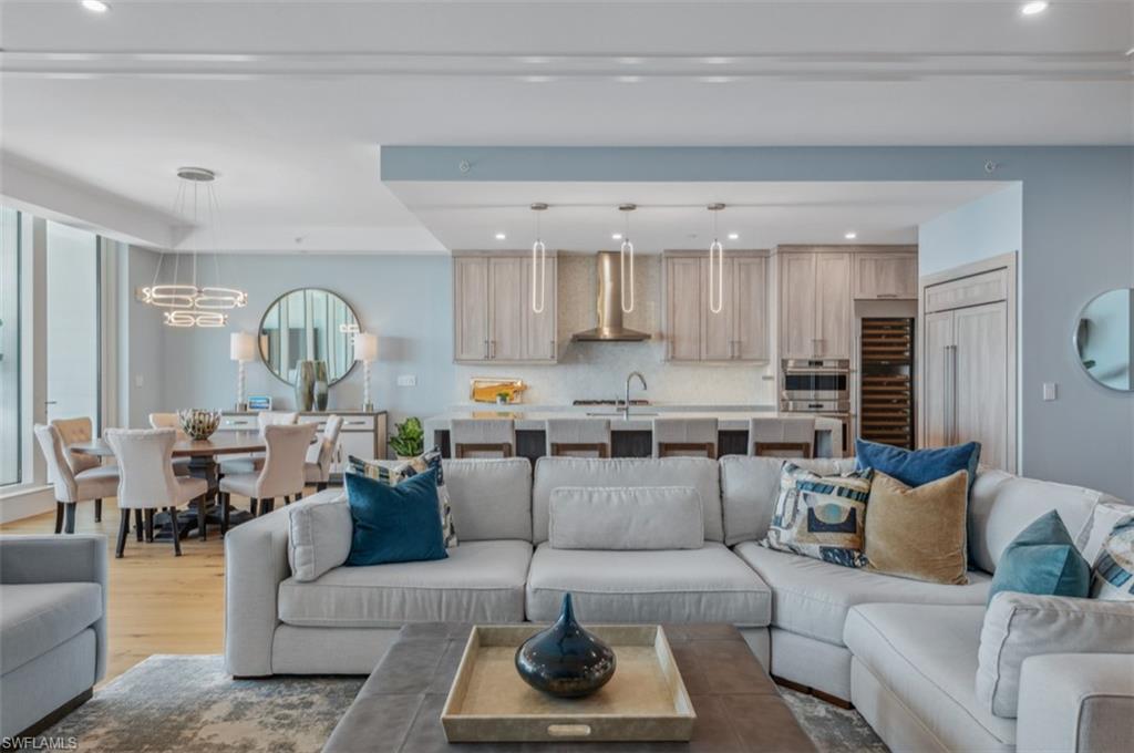 13925 Old Coast Road, Unit PH02 Naples, FL 34110 - Photo 15 of 33 a living room with furniture and wooden floor