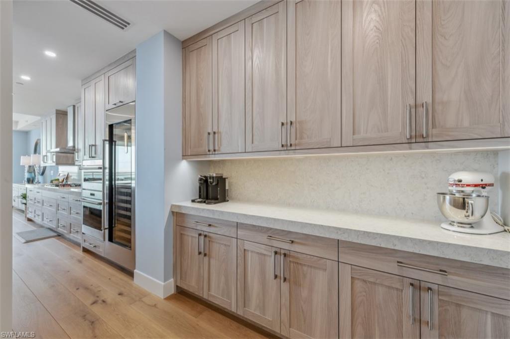 13925 Old Coast Road, Unit PH02 Naples, FL 34110 - Photo 17 of 33 a kitchen with stainless steel appliances granite countertop a refrigerator and cabinets