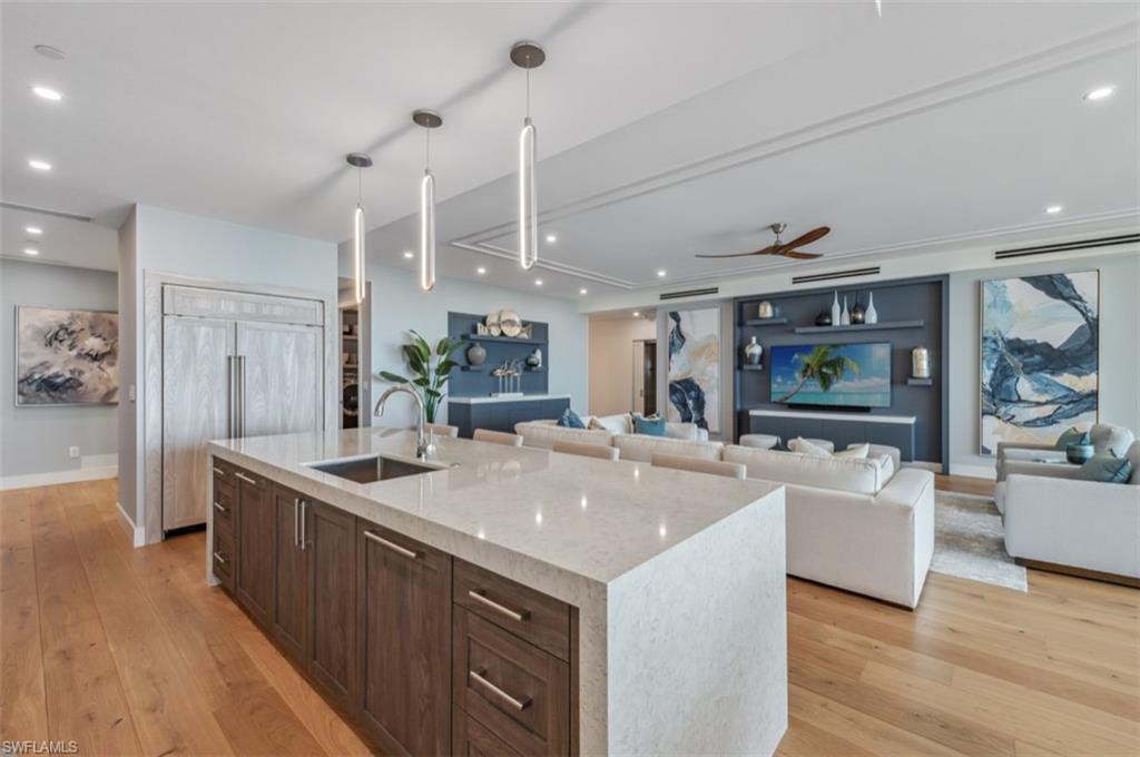 13925 Old Coast Road, Unit PH02 Naples, FL 34110 - Photo 19 of 33 a large kitchen with kitchen island a large counter top space and stainless steel appliances