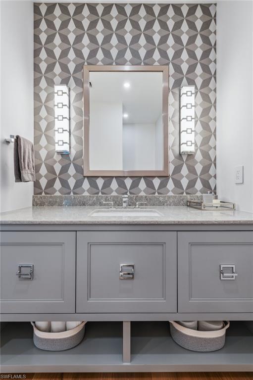 13925 Old Coast Road, Unit PH02 Naples, FL 34110 - Photo 23 of 33 a bathroom with a sink and a mirror
