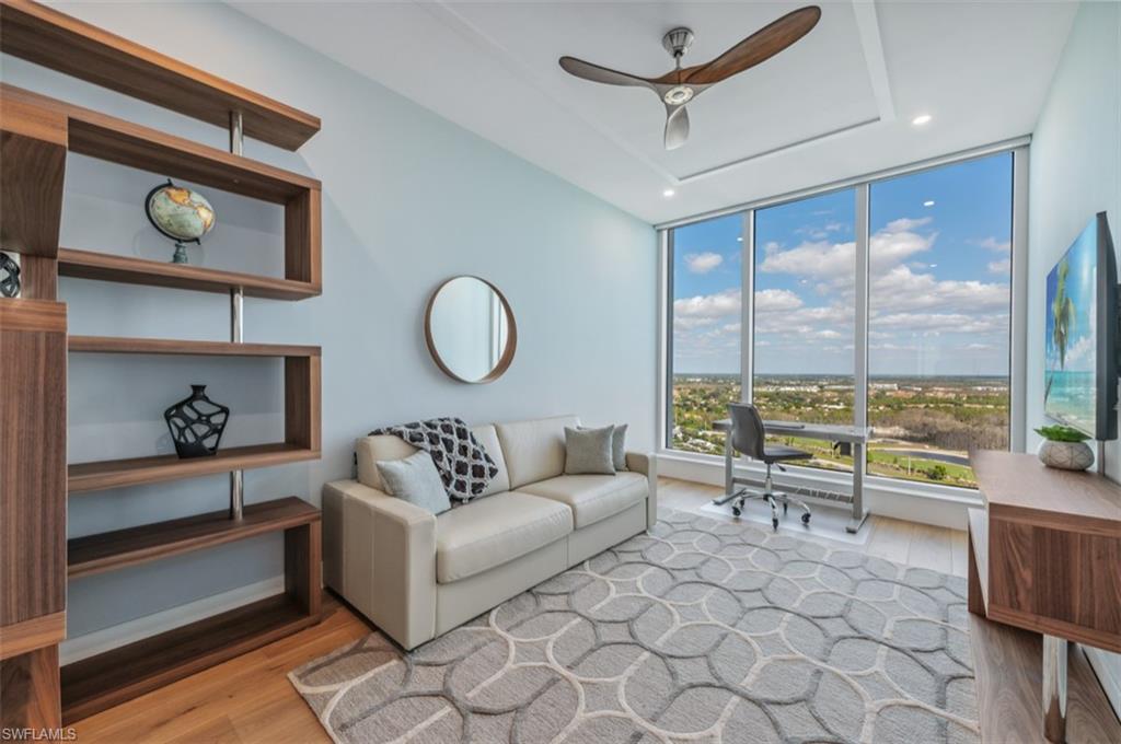 13925 Old Coast Road, Unit PH02 Naples, FL 34110 - Photo 24 of 33 a living room with furniture and a floor to ceiling window