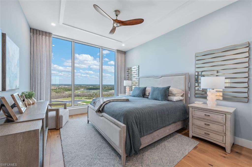 13925 Old Coast Road, Unit PH02 Naples, FL 34110 - Photo 27 of 33 a spacious bedroom with a bed and a large window