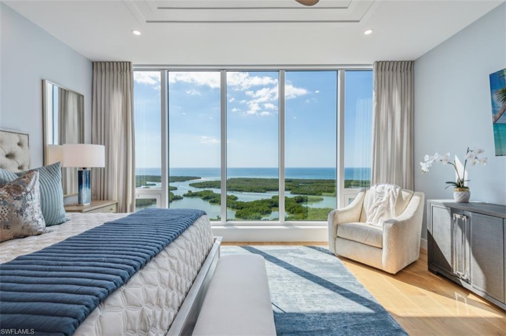 13925 Old Coast Road, Unit PH02 Naples, FL 34110 - Photo 3 of 33 a spacious bedroom with a large window and a couch