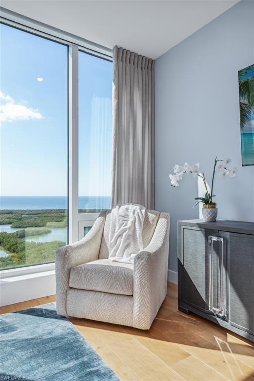 13925 Old Coast Road, Unit PH02 Naples, FL 34110 - Photo 4 of 33 a living room with furniture and a floor to ceiling window