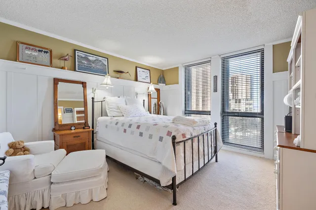 a bedroom with a bed couch and a window