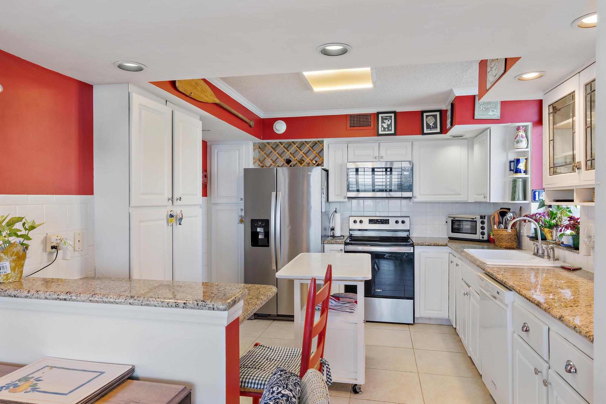 5380 North Ocean Drive, Unit 6D Singer Island, FL 33404 - Photo 10 of 41 a kitchen with granite countertop a sink stove and refrigerator