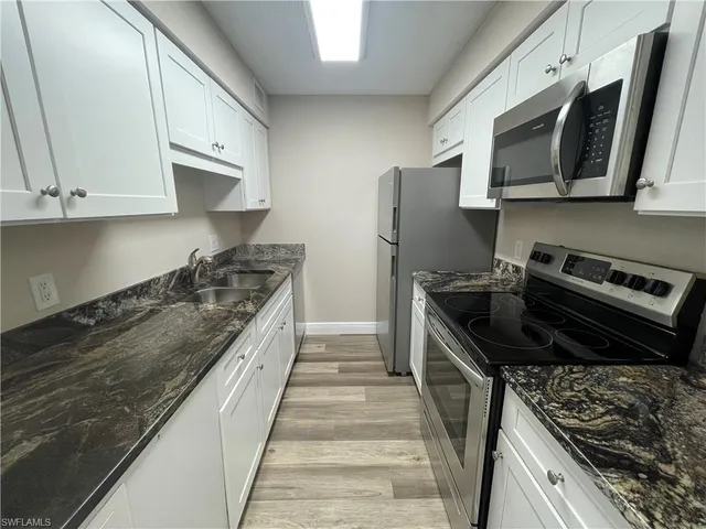 a kitchen with stainless steel appliances granite countertop a stove and a refrigerator