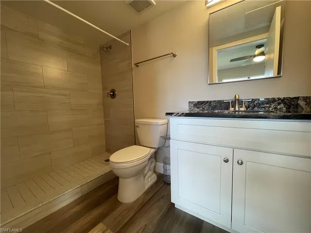 a white toilet sitting next to a bathroom sink