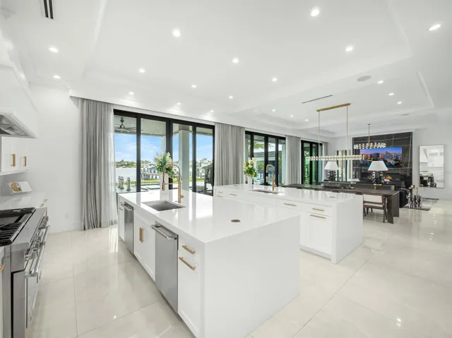 a bedroom with a large bed and large windows