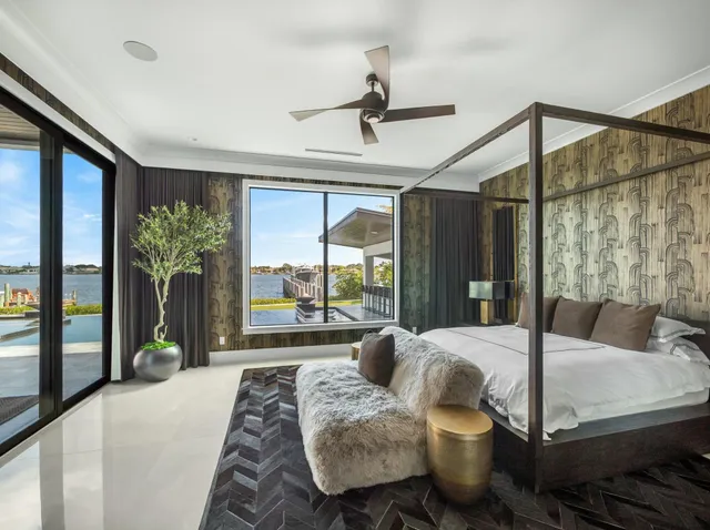 a spacious bedroom with a bed a couch and a flat screen tv