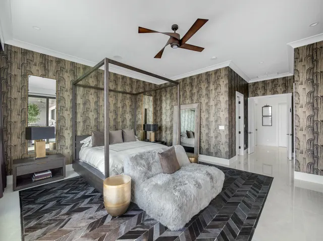 a living room with a couch and a floor to ceiling window