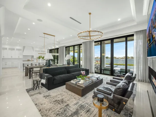 a living room with furniture kitchen and a chandelier