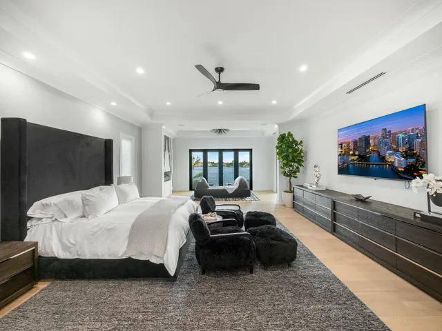 a front view of a house with a yard and potted plants