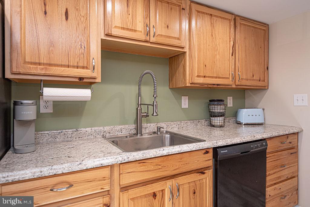 9530 Peerless Road Bishopville, MD 21813 - Photo 16 of 51 a kitchen with granite countertop stainless steel appliances granite countertop a sink and cabinets