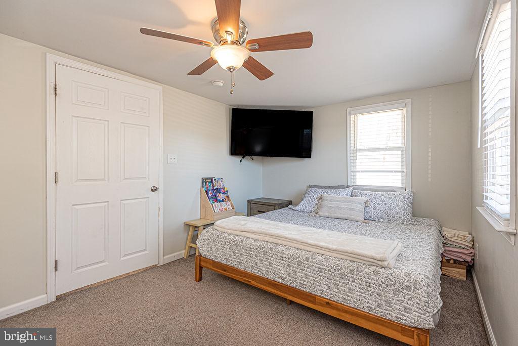 9530 Peerless Road Bishopville, MD 21813 - Photo 30 of 51 a bedroom with a bed a flat screen tv and a window