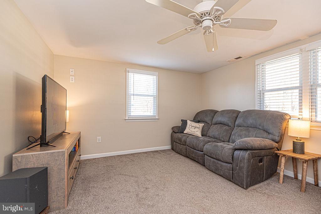 9530 Peerless Road Bishopville, MD 21813 - Photo 8 of 51 a living room with furniture and a flat screen tv