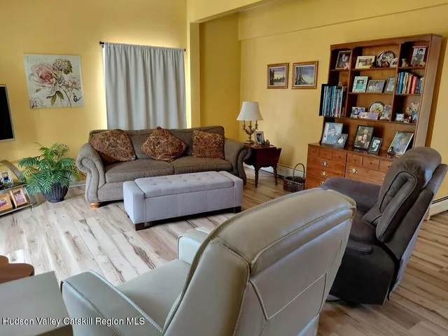 a living room with furniture and painting on the wall