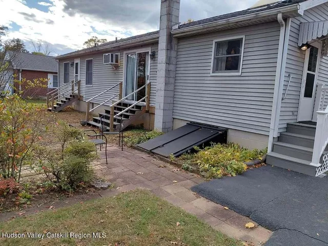 a view of a house with a yard and a patio
