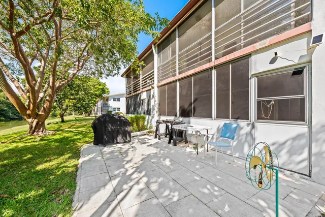 a view of a patio with table and chairs and potted plants