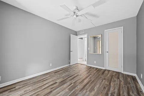 a view of an empty room with wooden floor