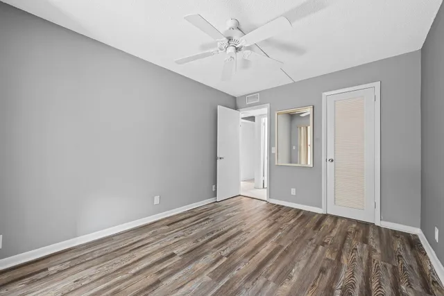 a view of an empty room with wooden floor
