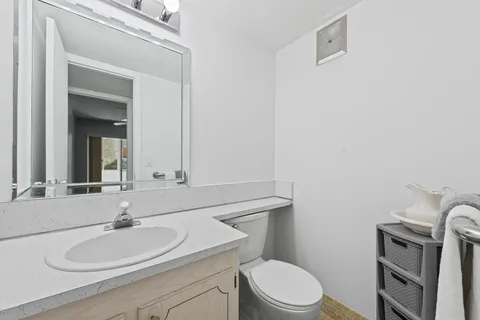 a bathroom with a sink a toilet and mirror