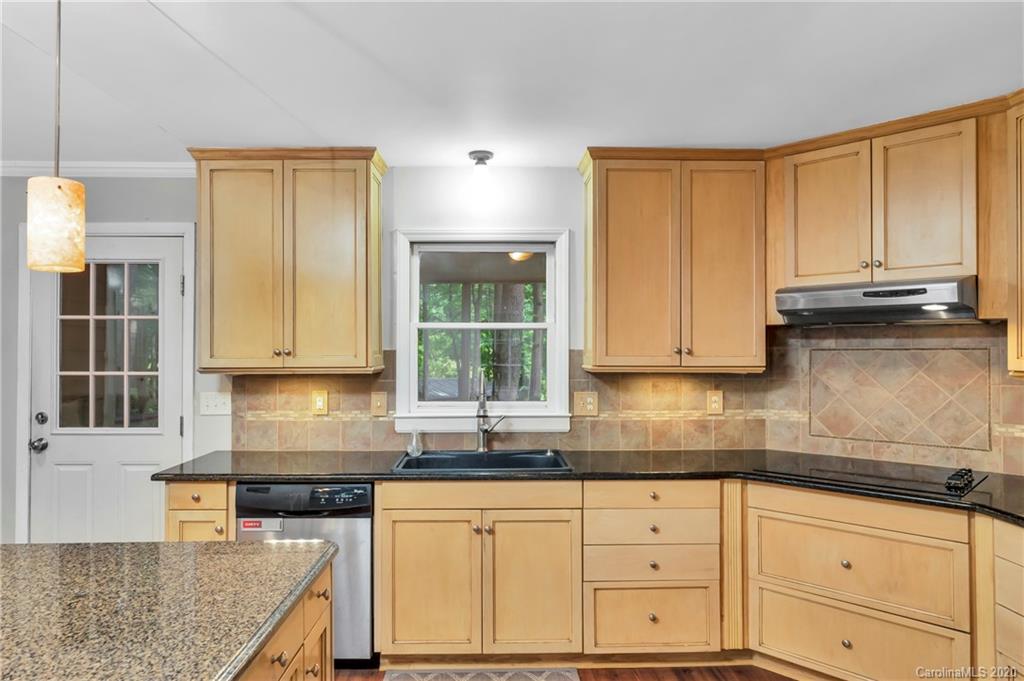 7109 New Town Road Waxhaw, NC 28173 - Photo 11 of 31 a kitchen with granite countertop a sink window and cabinets