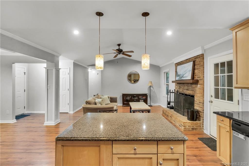 7109 New Town Road Waxhaw, NC 28173 - Photo 12 of 31 a kitchen with a table chairs and a fireplace