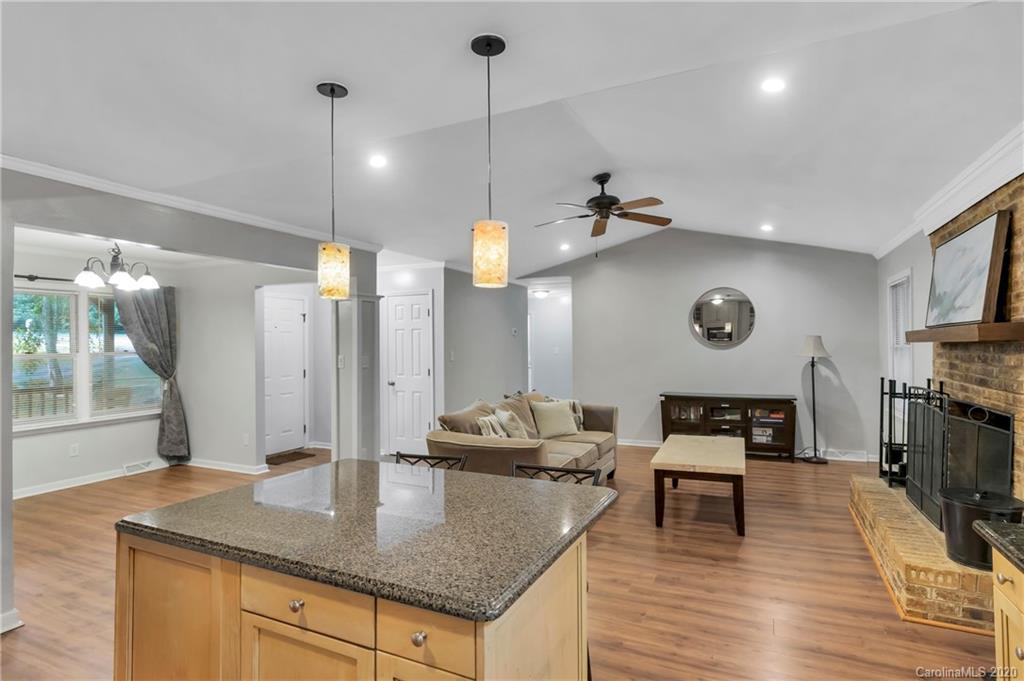 7109 New Town Road Waxhaw, NC 28173 - Photo 13 of 31 a kitchen with stainless steel appliances granite countertop a stove a refrigerator and a wooden cabinets