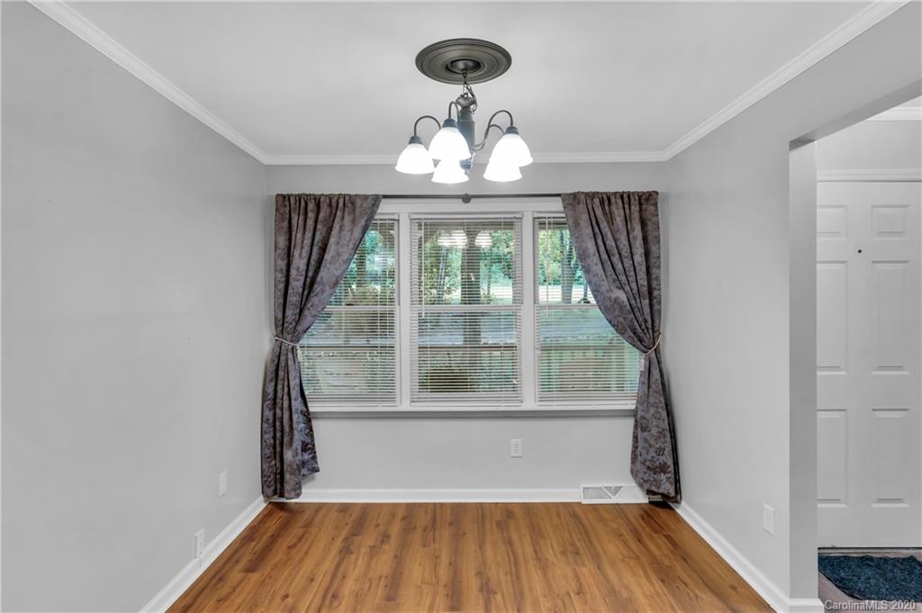 7109 New Town Road Waxhaw, NC 28173 - Photo 14 of 31 wooden floor in an empty room with a window