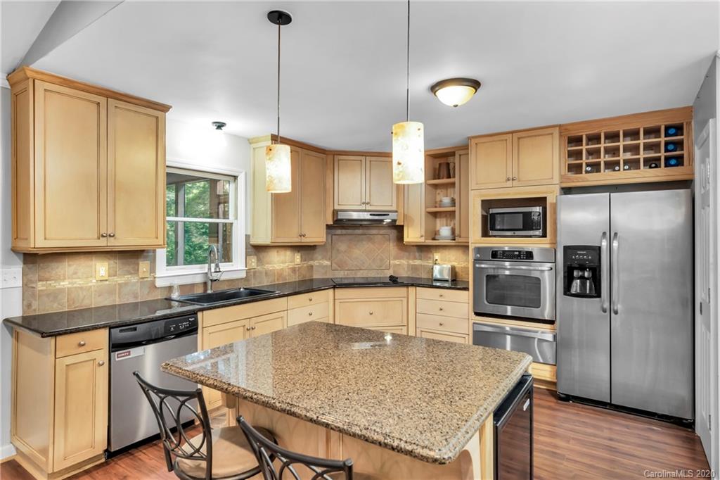 7109 New Town Road Waxhaw, NC 28173 - Photo 10 of 31 a kitchen with stainless steel appliances granite countertop a sink dishwasher stove refrigerator and microwave