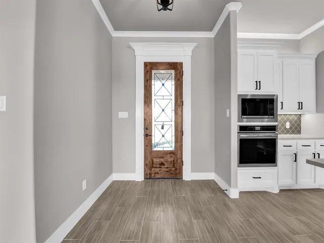 a view of kitchen with sink and refrigerator