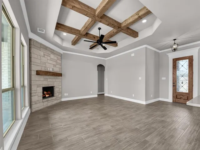 wooden floor in an empty room with a fireplace
