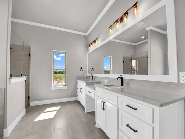 a hall with a sink cabinets and a window