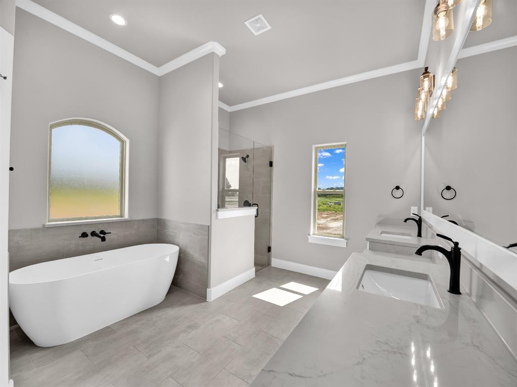 2000 Forest Bridge Drive Azle, TX 76020 - Photo 31 of 34 a spacious bathroom with a double vanity sink a mirror and a bathtub