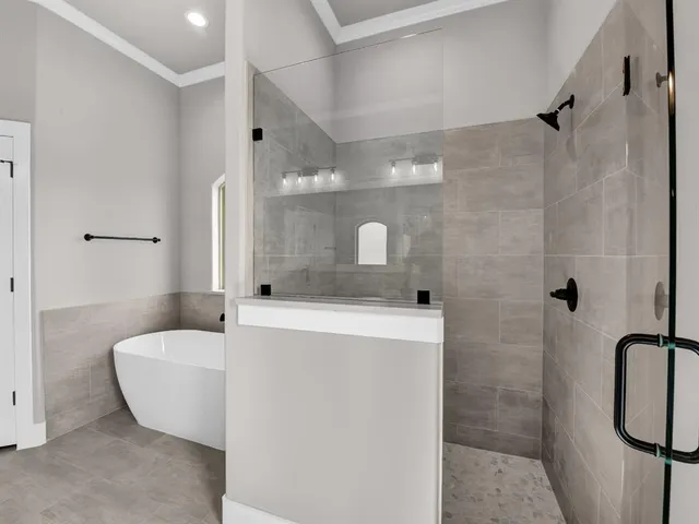 a bathroom with a tub sink and mirror