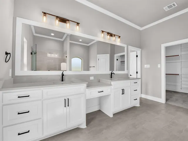 a spacious bathroom with double sink and a mirror