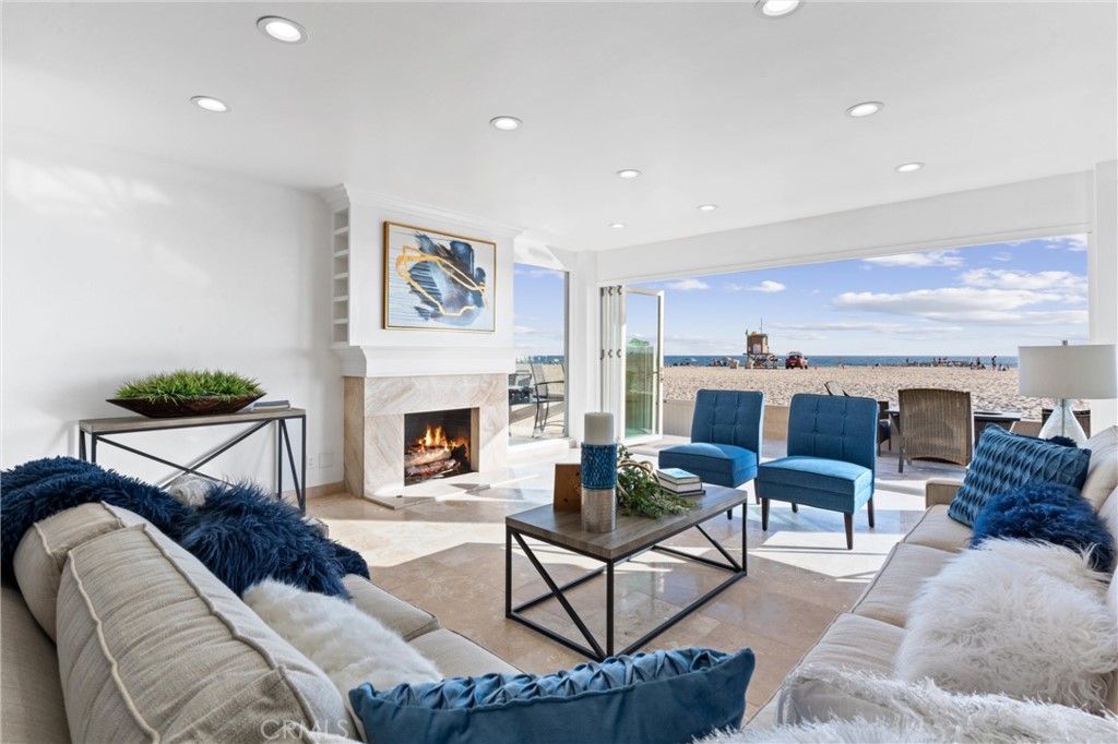 2804 West Oceanfront Newport Beach, CA 92663 - Photo 3 of 41 a living room with furniture and a fireplace