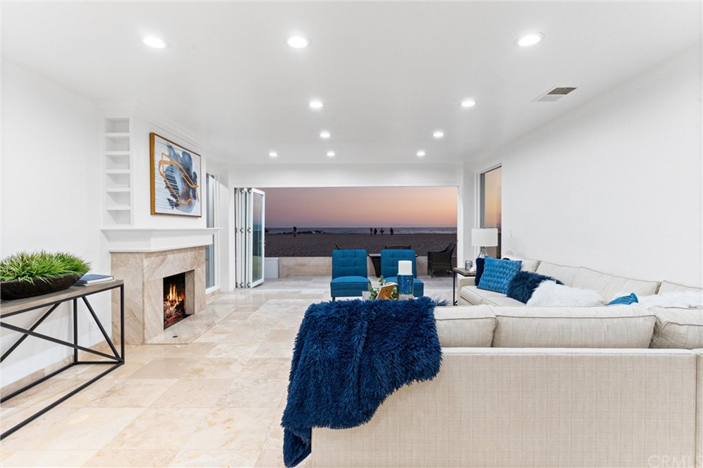 2804 West Oceanfront Newport Beach, CA 92663 - Photo 4 of 41 a living room with furniture and a fireplace