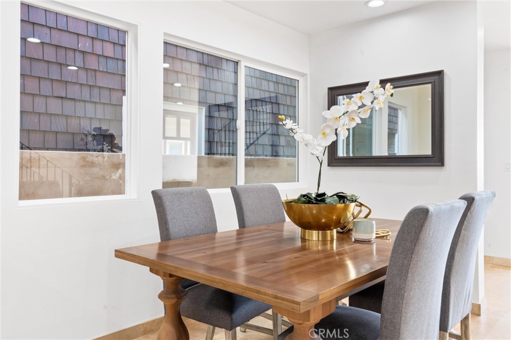 2804 West Oceanfront Newport Beach, CA 92663 - Photo 7 of 41 a view of a dining room with furniture and wooden floor
