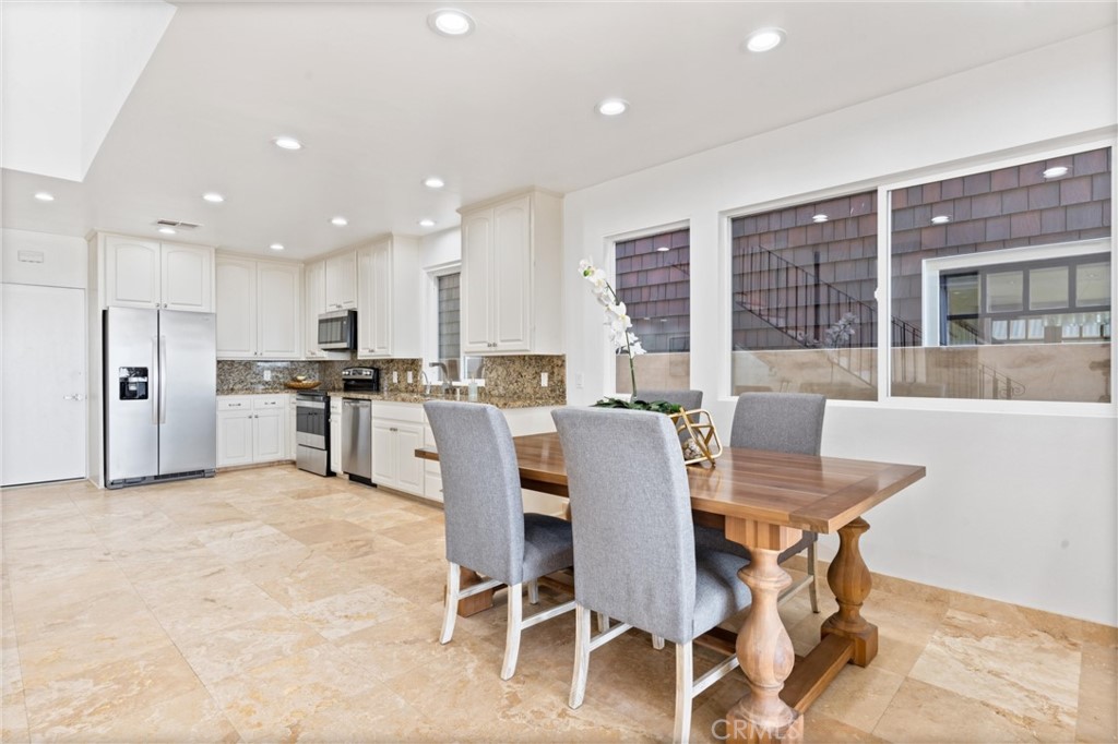 2804 West Oceanfront Newport Beach, CA 92663 - Photo 8 of 41 a view of kitchen with refrigerator dining table and chairs